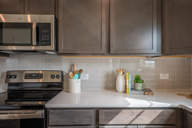303 Enfield Dr, Carthage, NC 28327 - kitchen featuring appliances with stainless steel finishes, light countertops, backsplash, and dark brown cabinets