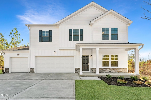 303 Enfield Dr, Carthage, NC 28327 - view of front facade featuring stone siding, driveway, a porch, a front yard, and an attached garage