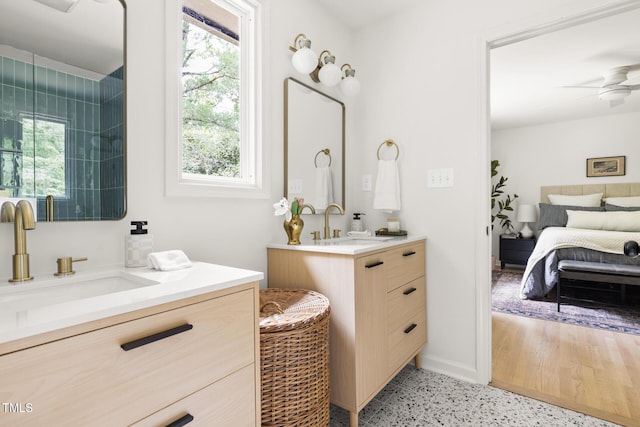939 Clarion Dr, Durham, NC 27705 - bathroom with two vanities, speckle patterned floor, ensuite bathroom, and a ceiling fan