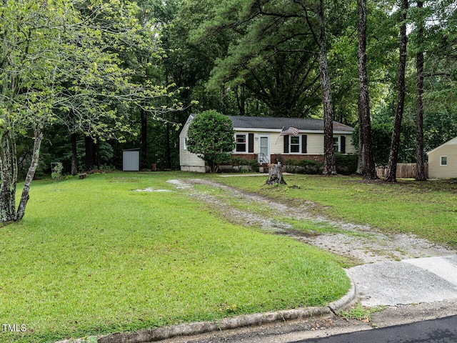 203 Lane Of Sir Kay, Garner, NC 27529 - view of front of home featuring dirt driveway, brick siding, and a front lawn