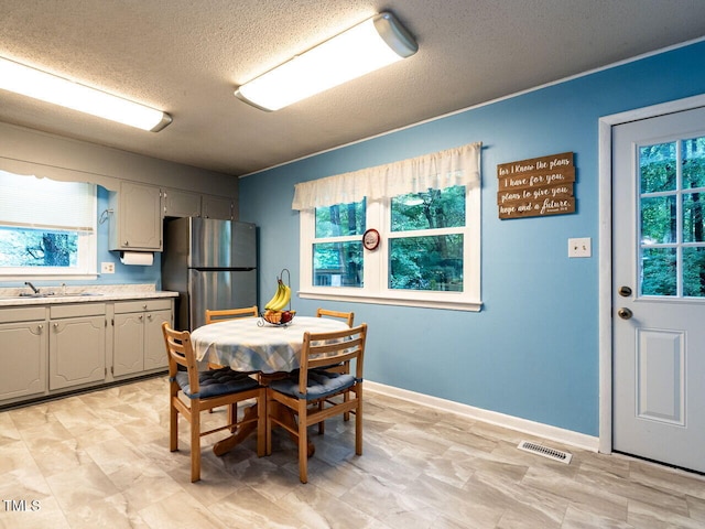 203 Lane Of Sir Kay, Garner, NC 27529 - dining space featuring a textured ceiling and baseboards