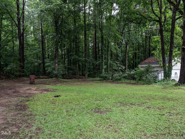 203 Lane Of Sir Kay, Garner, NC 27529 - view of grassy yard with a forest view