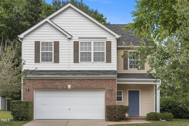 702 Calavaras Ln, Knightdale, NC 27545 - view of front of property featuring brick siding, driveway, an attached garage, and a shingled roof