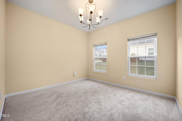 702 Calavaras Ln, Knightdale, NC 27545 - spare room featuring a chandelier and carpet
