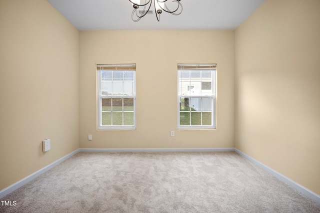 702 Calavaras Ln, Knightdale, NC 27545 - carpeted spare room with a chandelier and baseboards