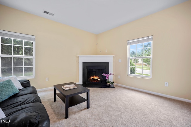 702 Calavaras Ln, Knightdale, NC 27545 - carpeted living area with a fireplace with flush hearth and baseboards