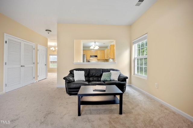 702 Calavaras Ln, Knightdale, NC 27545 - carpeted living area featuring a chandelier and baseboards