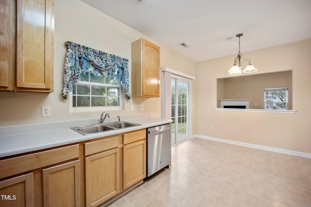 702 Calavaras Ln, Knightdale, NC 27545 - kitchen with dishwasher, light brown cabinets, light countertops, and hanging light fixtures