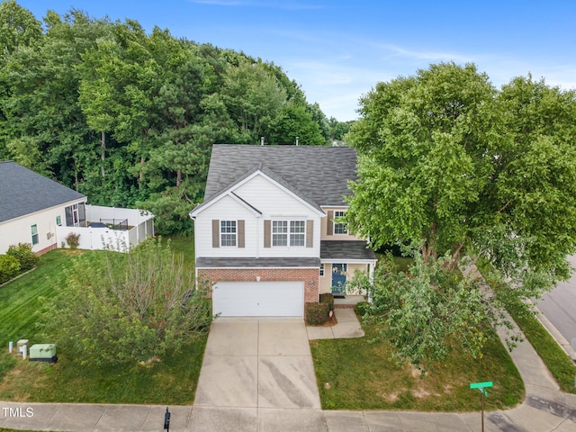 702 Calavaras Ln, Knightdale, NC 27545 - view of front of house with brick siding, a garage, driveway, and roof with shingles