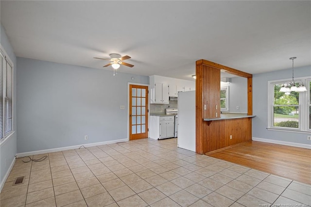 6425 Morganton Rd, Fayetteville, NC 28314 - unfurnished living room with ceiling fan, light tile patterned flooring, a chandelier, and baseboards