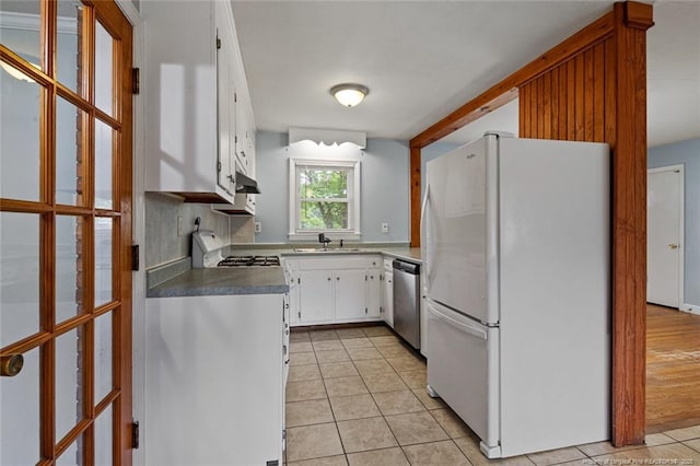 6425 Morganton Rd, Fayetteville, NC 28314 - kitchen with freestanding refrigerator, stainless steel dishwasher, light tile patterned flooring, a sink, and stove