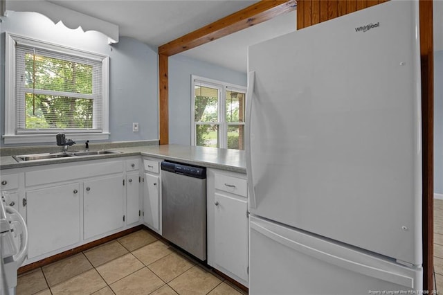 6425 Morganton Rd, Fayetteville, NC 28314 - kitchen featuring freestanding refrigerator, stainless steel dishwasher, a sink, light tile patterned floors, and beamed ceiling