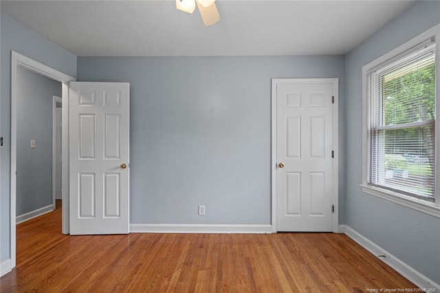 6425 Morganton Rd, Fayetteville, NC 28314 - unfurnished bedroom featuring wood finished floors, baseboards, and ceiling fan