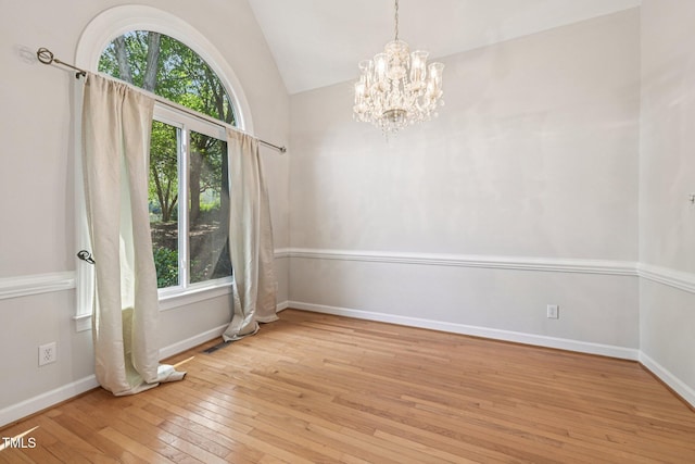 316 Trafalgar Ln, Cary, NC 27513 - unfurnished room featuring plenty of natural light, hardwood / wood-style floors, a chandelier, and vaulted ceiling