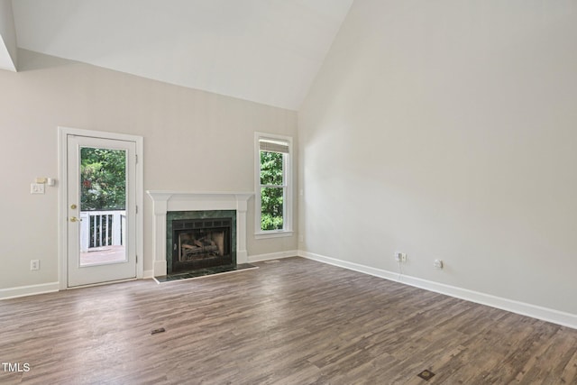 316 Trafalgar Ln, Cary, NC 27513 - unfurnished living room featuring healthy amount of natural light, wood finished floors, high vaulted ceiling, and a high end fireplace