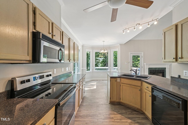 316 Trafalgar Ln, Cary, NC 27513 - kitchen with appliances with stainless steel finishes, wood finished floors, a peninsula, dark countertops, and a ceiling fan