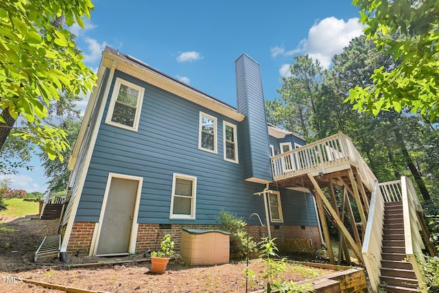 316 Trafalgar Ln, Cary, NC 27513 - rear view of house featuring stairs, a wooden deck, and a chimney