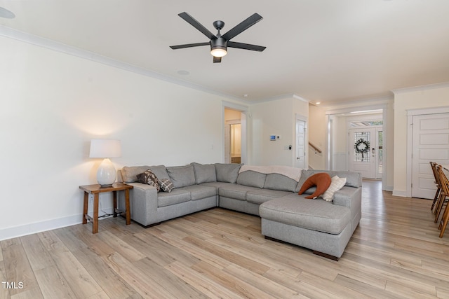 40 Ironwood Blvd, Youngsville, NC 27596 - living room featuring crown molding, light wood-type flooring, ceiling fan, and stairway