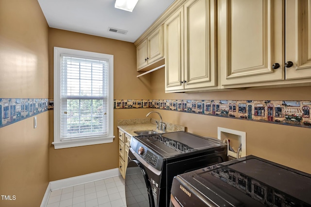 100 Highfield Ave, Cary, NC 27519 - washroom featuring cabinet space, washer and dryer, and light tile patterned floors