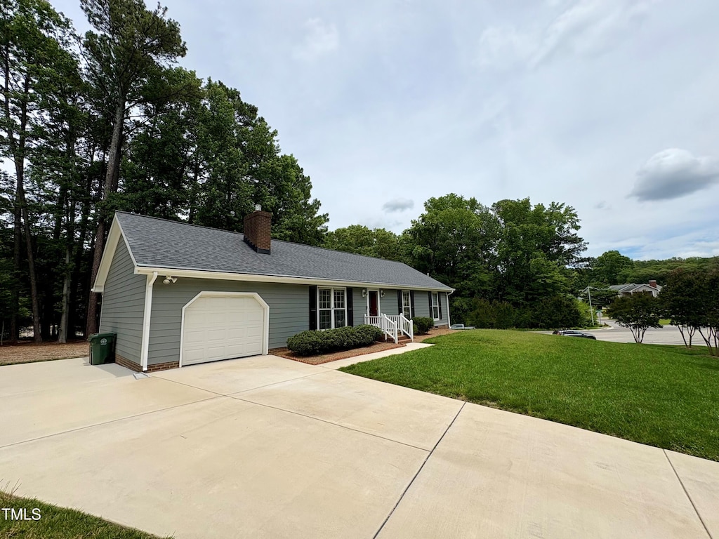 100 Honeysuckle Ln, Cary, NC 27513 - ranch-style home featuring a garage, driveway, a front lawn, a chimney, and roof with shingles