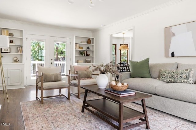 16 Cedar Hill Dr, Durham, NC 27713 - living area featuring built in shelves, ornamental molding, french doors, and wood finished floors