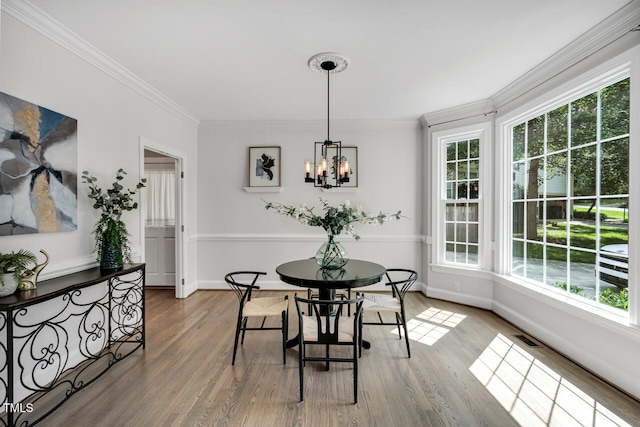 12 Gatesway Ct, Durham, NC 27707 - dining area featuring healthy amount of natural light, wood finished floors, ornamental molding, and a chandelier