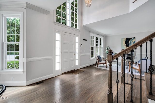 12 Gatesway Ct, Durham, NC 27707 - foyer featuring wood finished floors, crown molding, plenty of natural light, and stairs