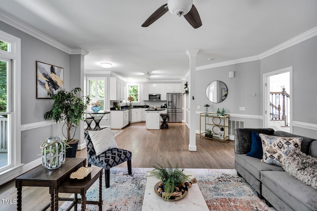 12 Gatesway Ct, Durham, NC 27707 - living room with crown molding, plenty of natural light, a ceiling fan, and light wood finished floors