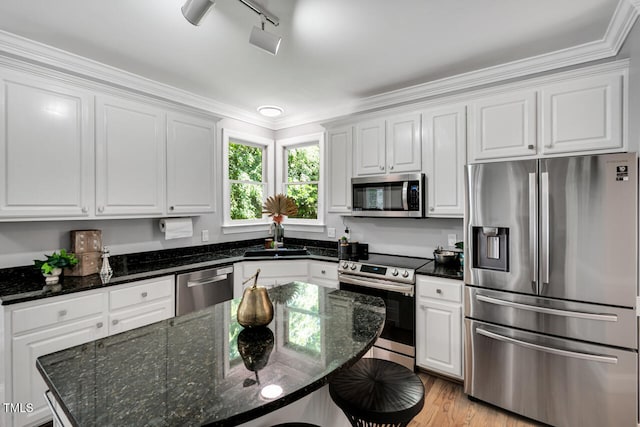 12 Gatesway Ct, Durham, NC 27707 - kitchen featuring appliances with stainless steel finishes, white cabinetry, a breakfast bar, light wood-type flooring, and dark stone counters