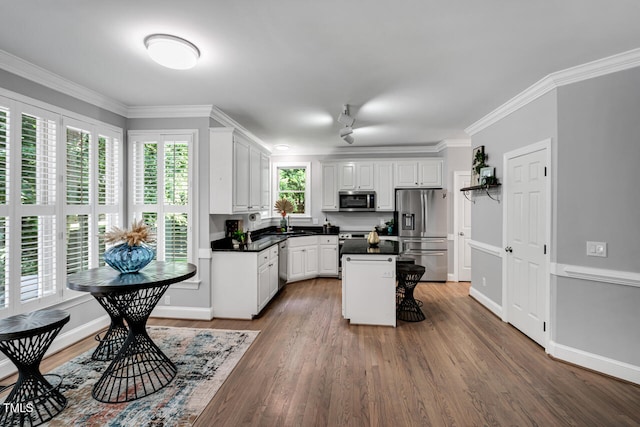 12 Gatesway Ct, Durham, NC 27707 - kitchen with stainless steel appliances, white cabinetry, dark countertops, a kitchen island, and wood finished floors