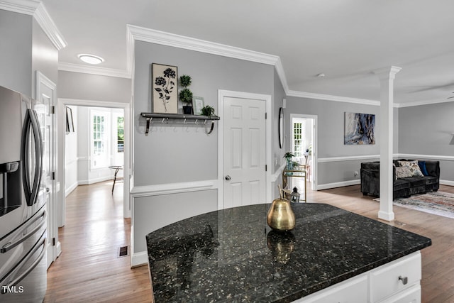 12 Gatesway Ct, Durham, NC 27707 - kitchen featuring stainless steel fridge, light wood-style floors, decorative columns, healthy amount of natural light, and crown molding