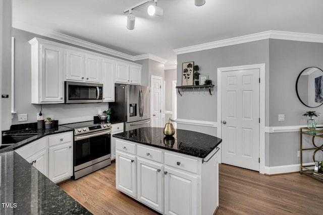 12 Gatesway Ct, Durham, NC 27707 - kitchen with appliances with stainless steel finishes, white cabinets, light wood-type flooring, ornamental molding, and dark stone counters