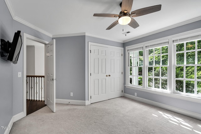 12 Gatesway Ct, Durham, NC 27707 - unfurnished bedroom with light colored carpet, crown molding, a ceiling fan, and a closet