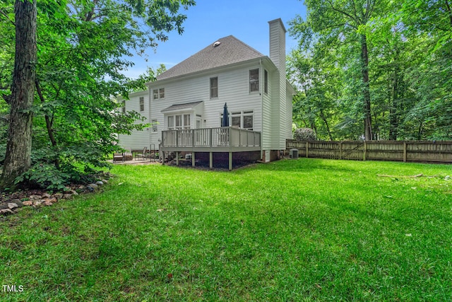 12 Gatesway Ct, Durham, NC 27707 - back of house featuring a wooden deck, a chimney, and a fenced backyard