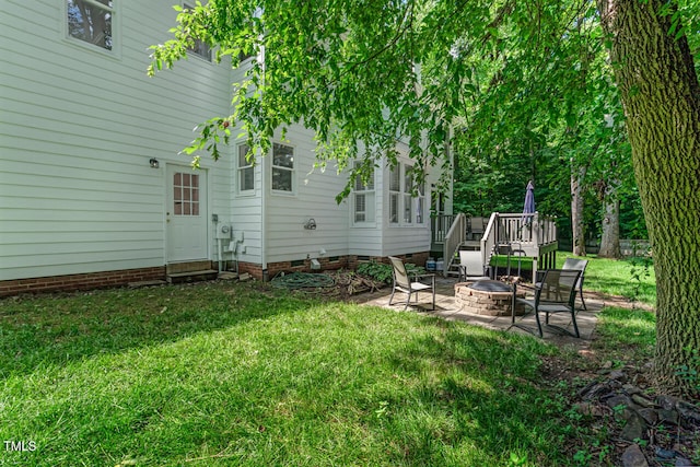 12 Gatesway Ct, Durham, NC 27707 - view of grassy yard with an outdoor fire pit, a patio area, and a wooden deck