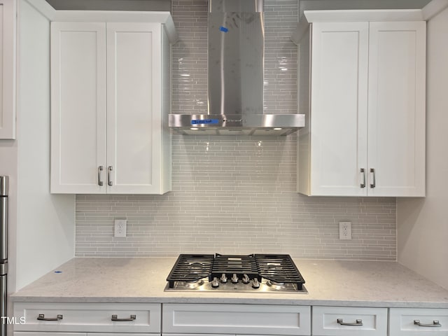 2203 Lambert Rd Unit 67, Cary, NC 27519 - kitchen featuring wall chimney exhaust hood, stainless steel gas stovetop, tasteful backsplash, and white cabinetry