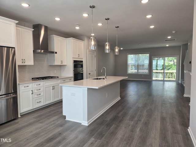 2203 Lambert Rd Unit 67, Cary, NC 27519 - kitchen featuring freestanding refrigerator, wall chimney exhaust hood, a sink, white cabinetry, and light countertops