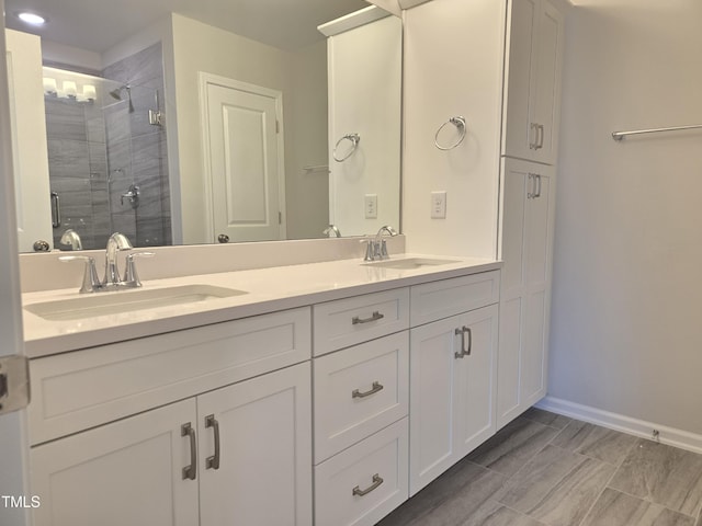 2203 Lambert Rd Unit 67, Cary, NC 27519 - full bathroom featuring double vanity, a shower stall, and baseboards