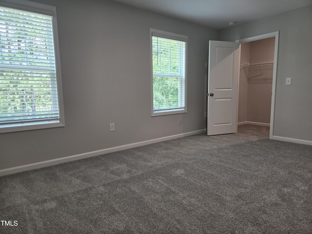 2203 Lambert Rd Unit 67, Cary, NC 27519 - unfurnished bedroom featuring carpet floors, baseboards, a walk in closet, and a closet