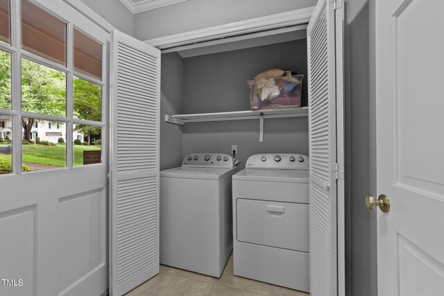 2301 Pastille Ln, Raleigh, NC 27612 - laundry area featuring independent washer and dryer, light tile patterned floors, and crown molding