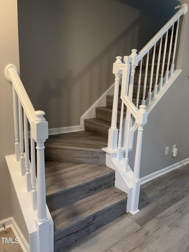 7710 River Field Dr, Raleigh, NC 27616 - staircase with wood finished floors and baseboards