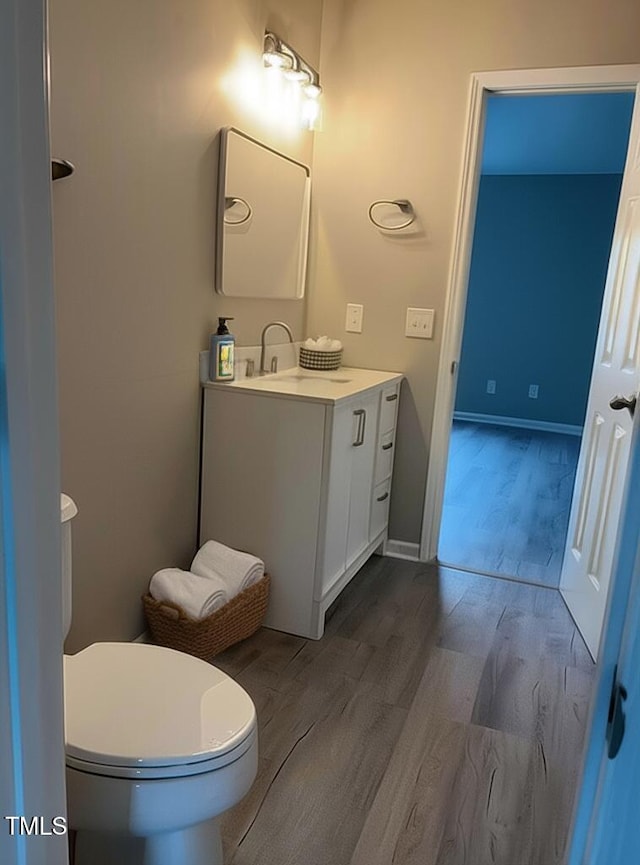 7710 River Field Dr, Raleigh, NC 27616 - bathroom featuring vanity, wood finished floors, and toilet