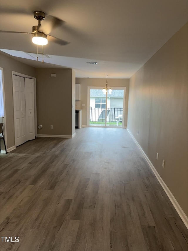 7710 River Field Dr, Raleigh, NC 27616 - unfurnished living room with a chandelier, dark wood-style floors, baseboards, and ceiling fan