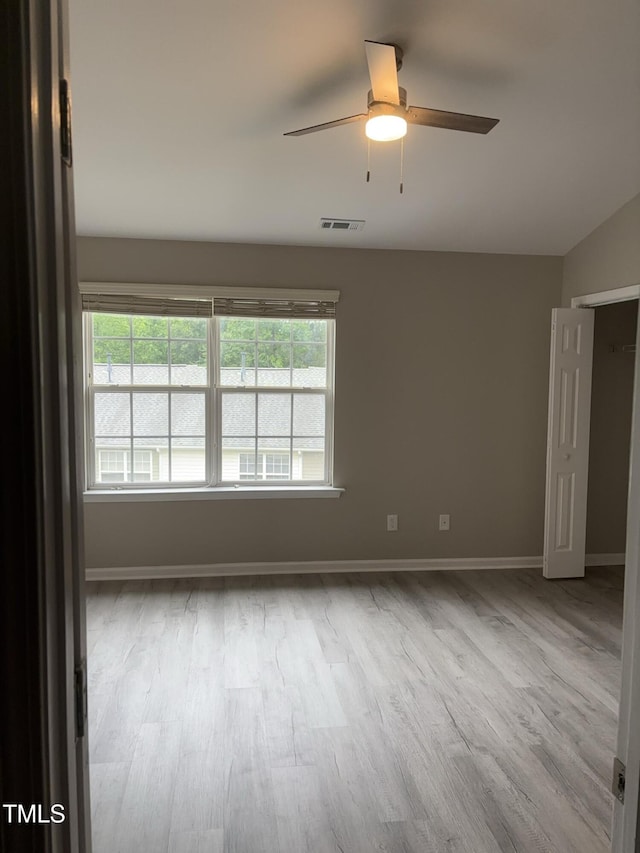 7710 River Field Dr, Raleigh, NC 27616 - empty room featuring wood finished floors, a ceiling fan, baseboards, and vaulted ceiling