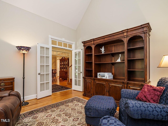 8504 Carlton Oaks Dr, Wake Forest, NC 27587 - living area featuring french doors, high vaulted ceiling, and wood finished floors