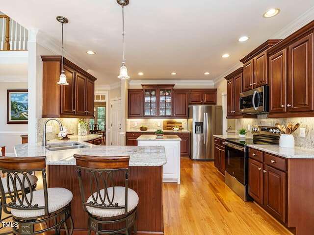 8504 Carlton Oaks Dr, Wake Forest, NC 27587 - kitchen with appliances with stainless steel finishes, a peninsula, ornamental molding, light wood finished floors, and decorative backsplash