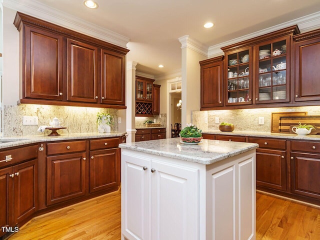8504 Carlton Oaks Dr, Wake Forest, NC 27587 - kitchen with light wood-style flooring, ornamental molding, decorative backsplash, glass insert cabinets, and recessed lighting