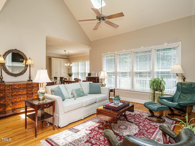8504 Carlton Oaks Dr, Wake Forest, NC 27587 - living room with high vaulted ceiling, light wood-style flooring, ceiling fan, and a chandelier