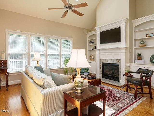 8504 Carlton Oaks Dr, Wake Forest, NC 27587 - living area with a ceiling fan, light wood-type flooring, a premium fireplace, and lofted ceiling