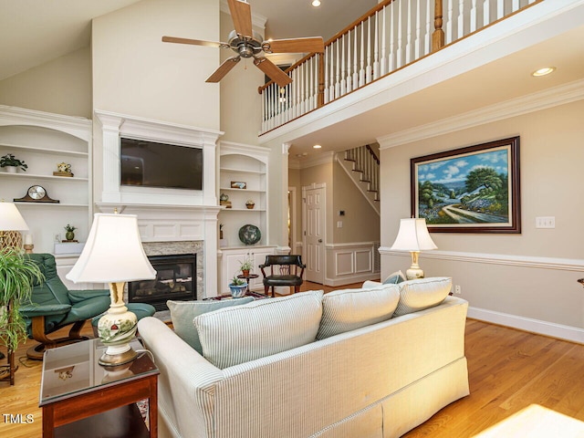 8504 Carlton Oaks Dr, Wake Forest, NC 27587 - living room with high vaulted ceiling, a fireplace, ceiling fan, wood finished floors, and built in shelves